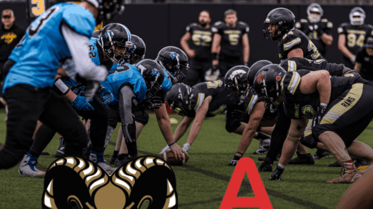 Yorkshire Rams American Football players lined up on a field against their opponents, with Yorkshire Rams and Aosom logos, representing a successful headline sports sponsorship deal.
